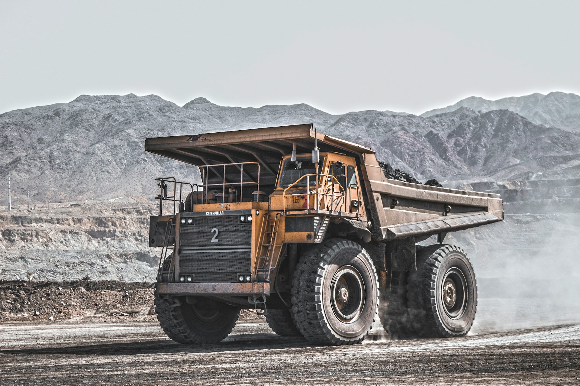 yellow and black heavy equipment on snow covered ground during daytime