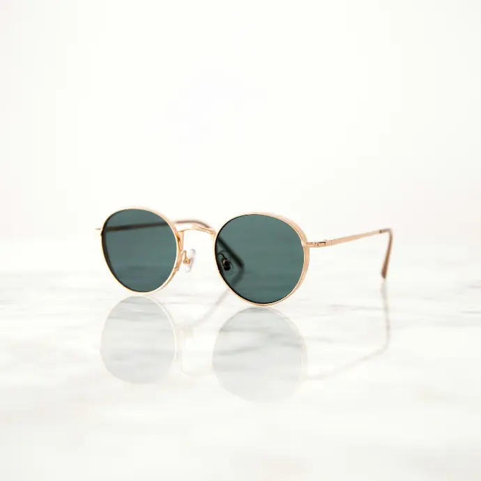 gold-colored framed hippie sunglasses on white surface