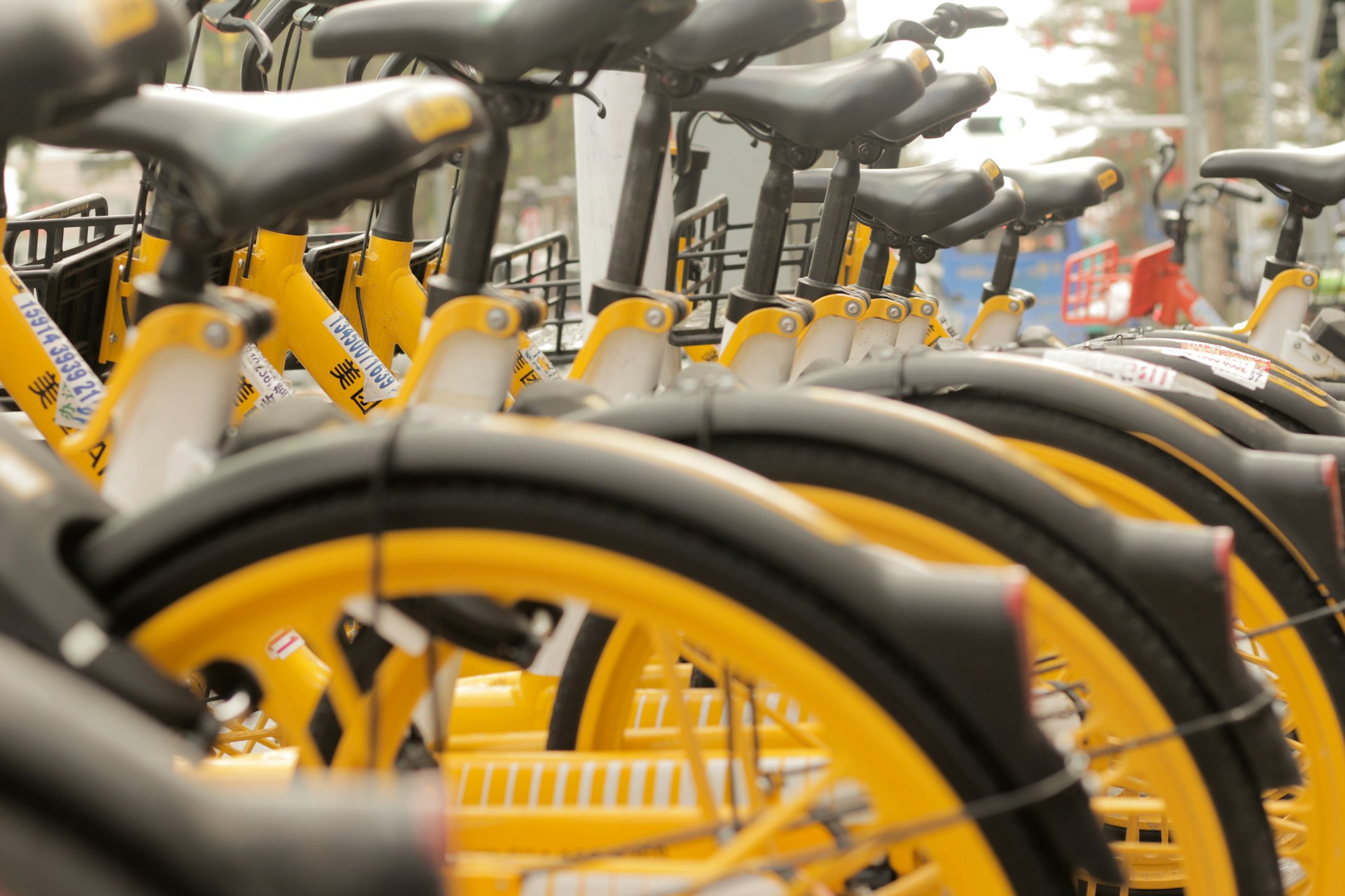 a row of yellow bicycles parked next to each other