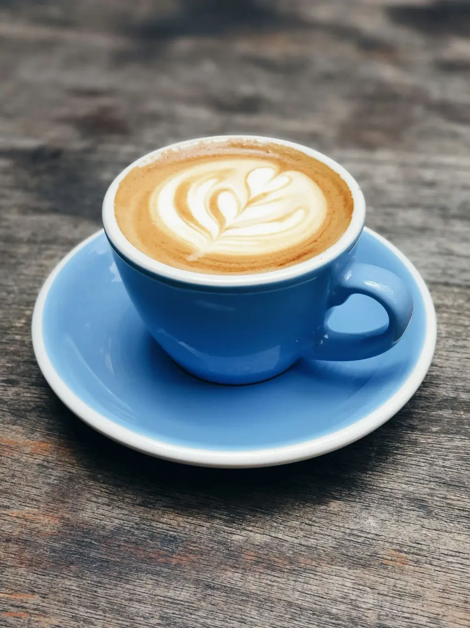 blue ceramic teacup with latte