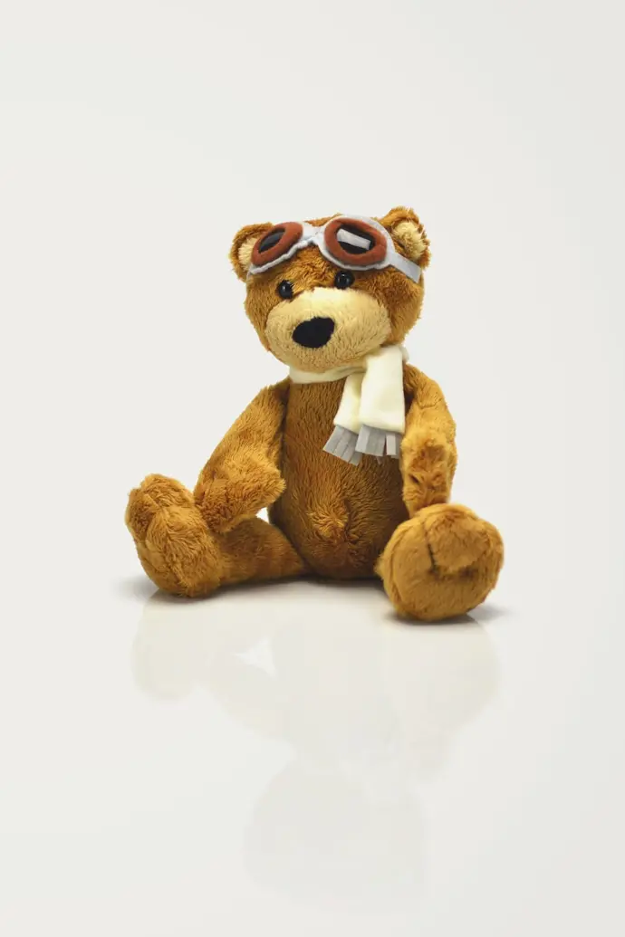 brown bear plush toy on white surface