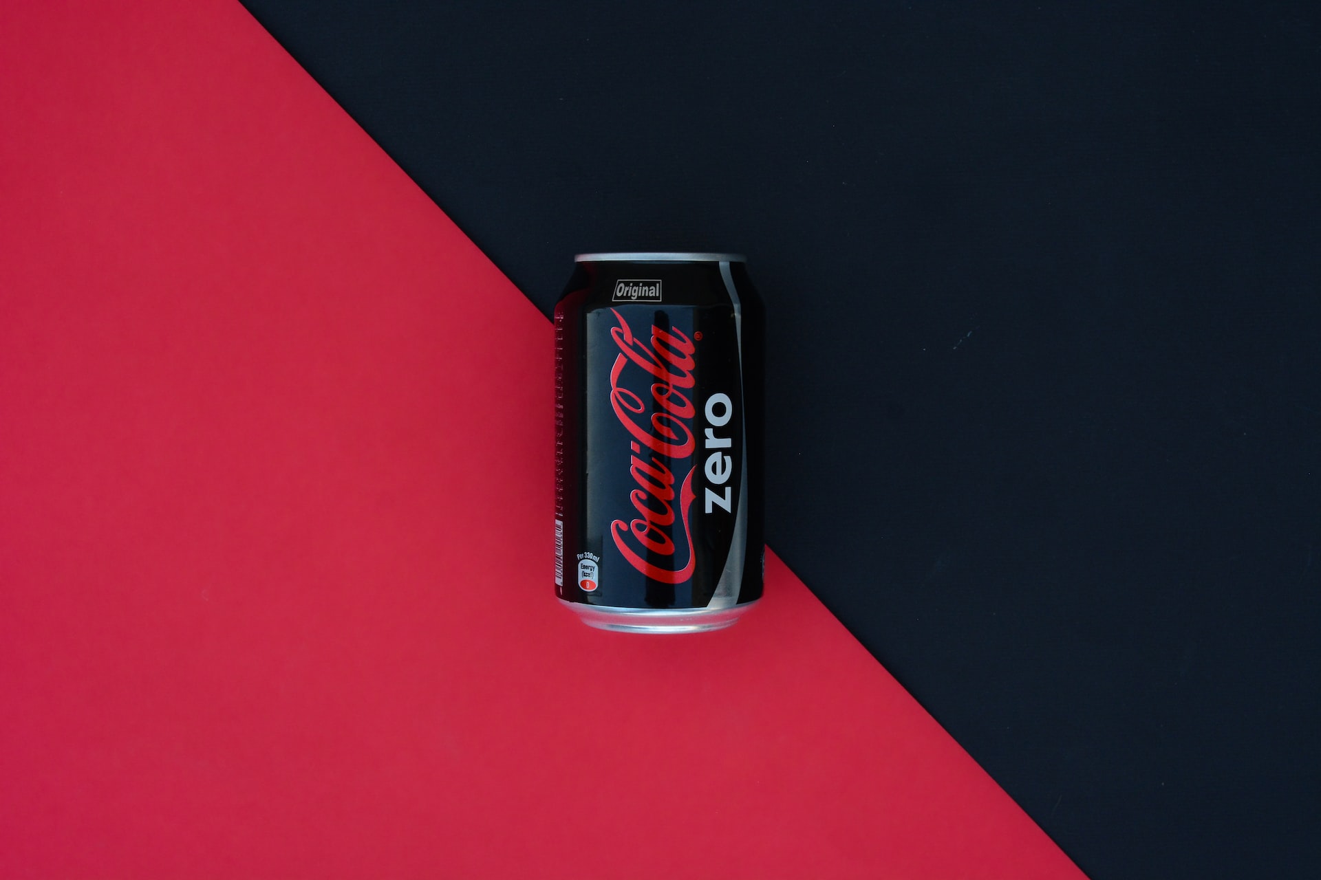 coca cola zero can on red table