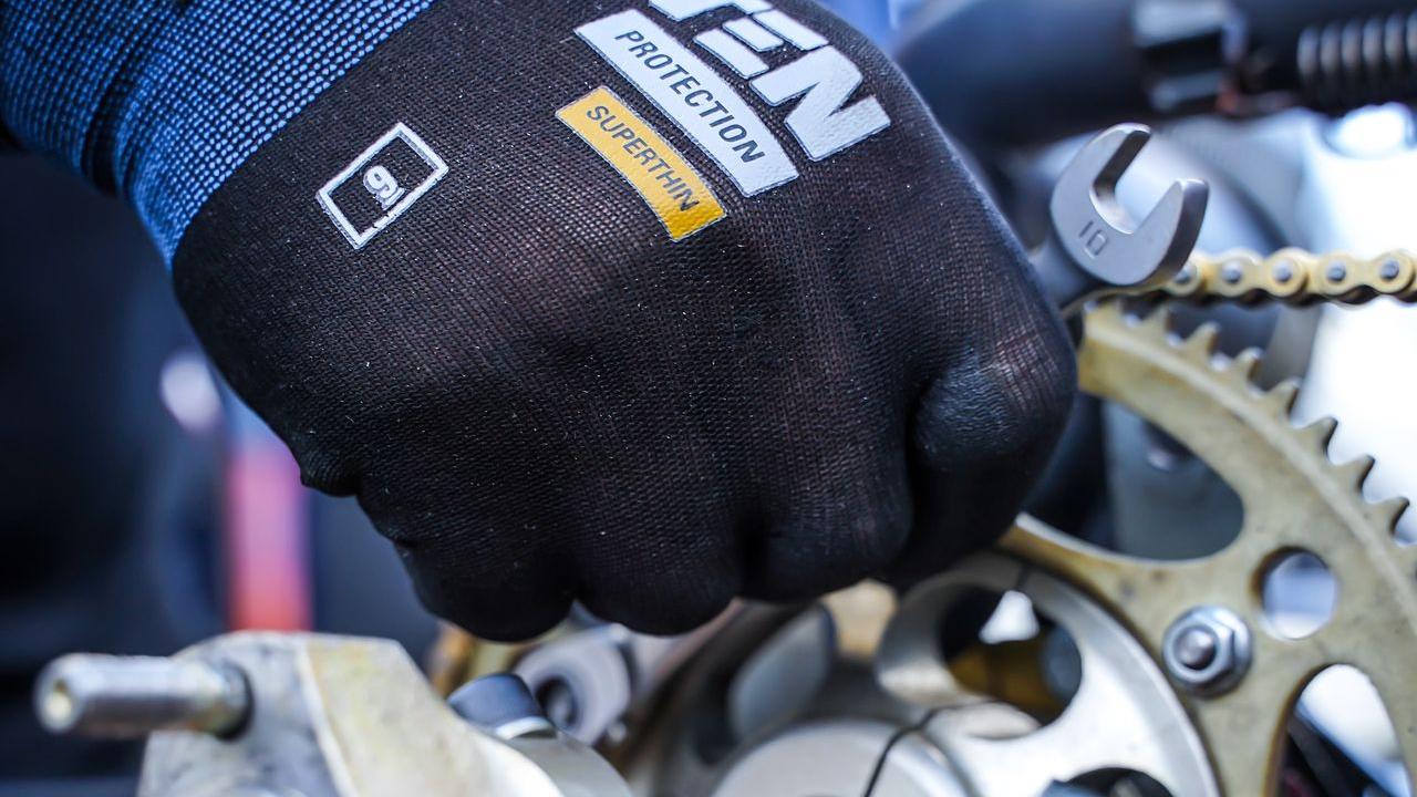 a close up of a working glove (PPE) holding equipment