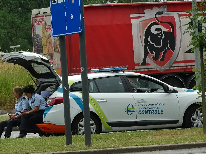 man in black jacket sitting on white car