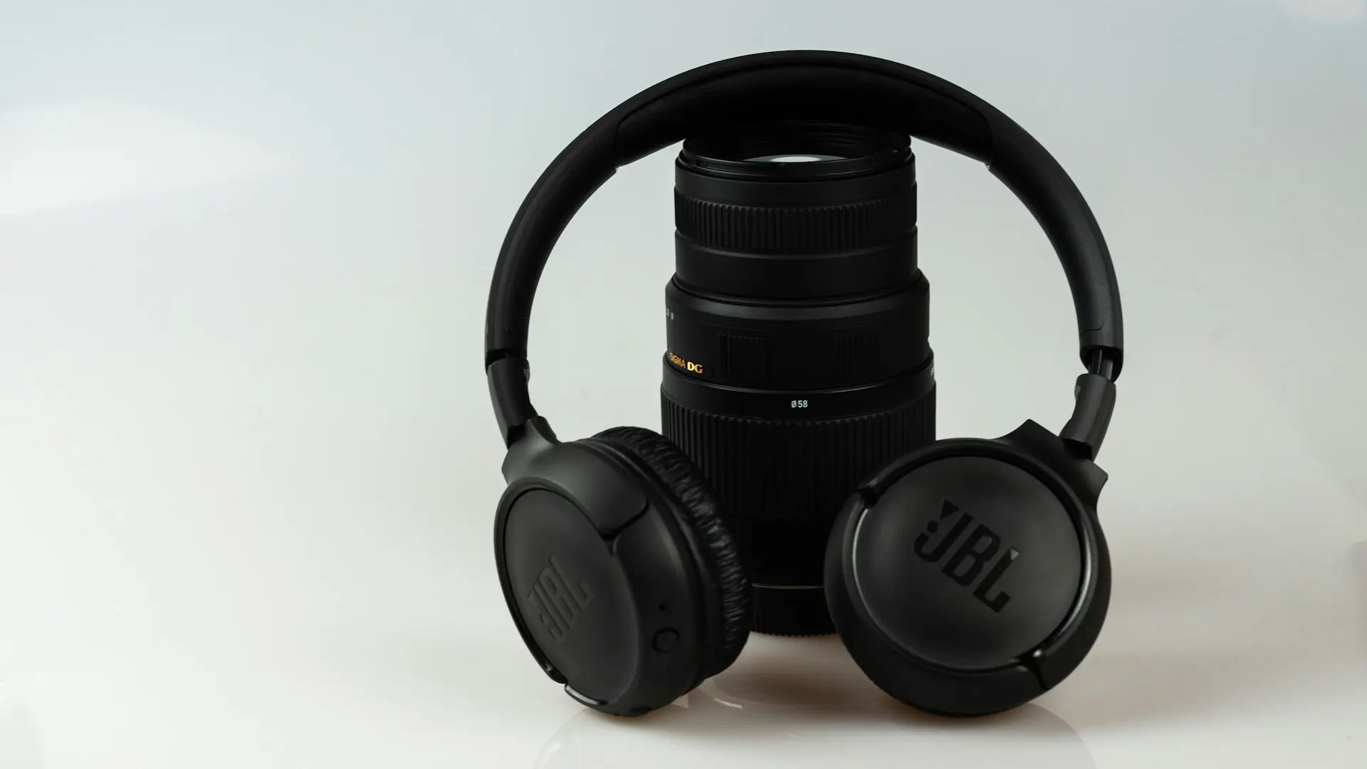 black JBL cordless headphones on black zoom lens